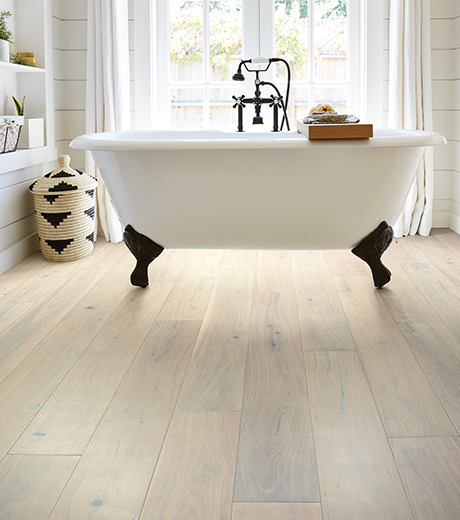 Bathroom with wood-look luxury vinyl flooring from Carneys Carpet Gallery in Jeffersontown, KY